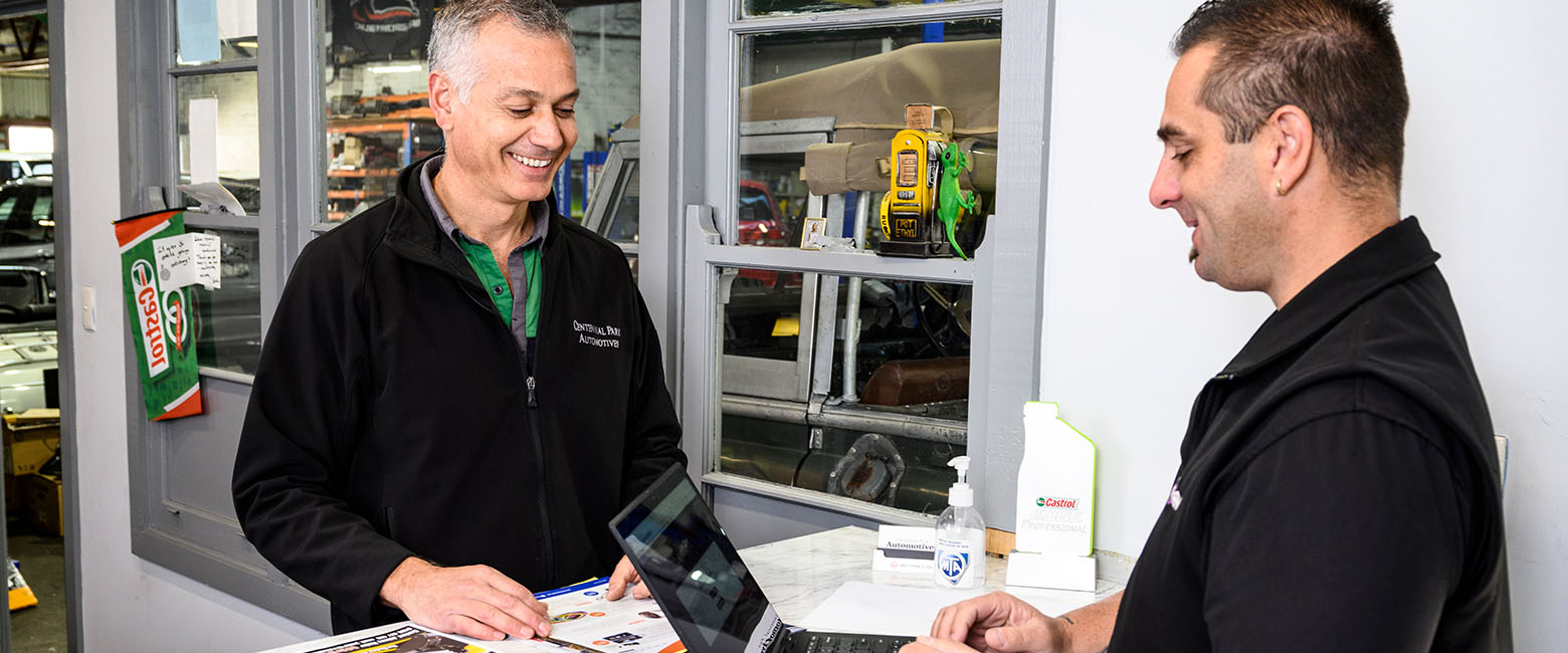 Two men using laptop