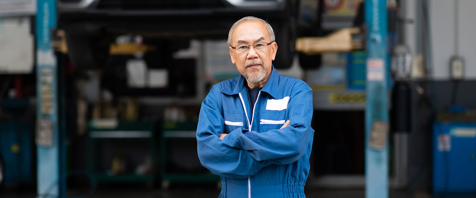 Man in front of workshop