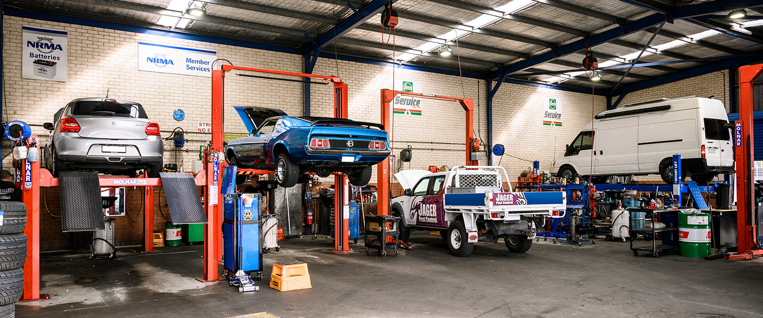 Cars being serviced in a workshop garage