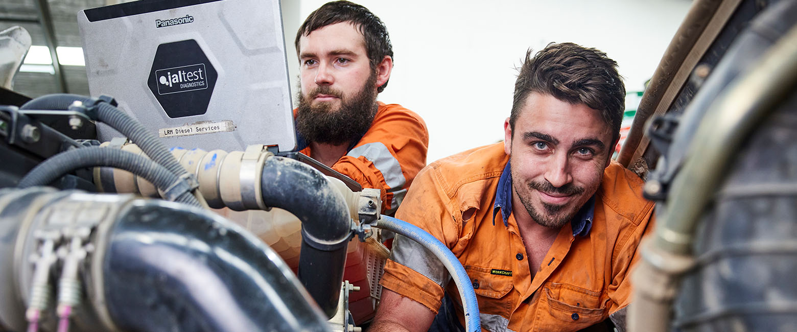 Two men working on truck