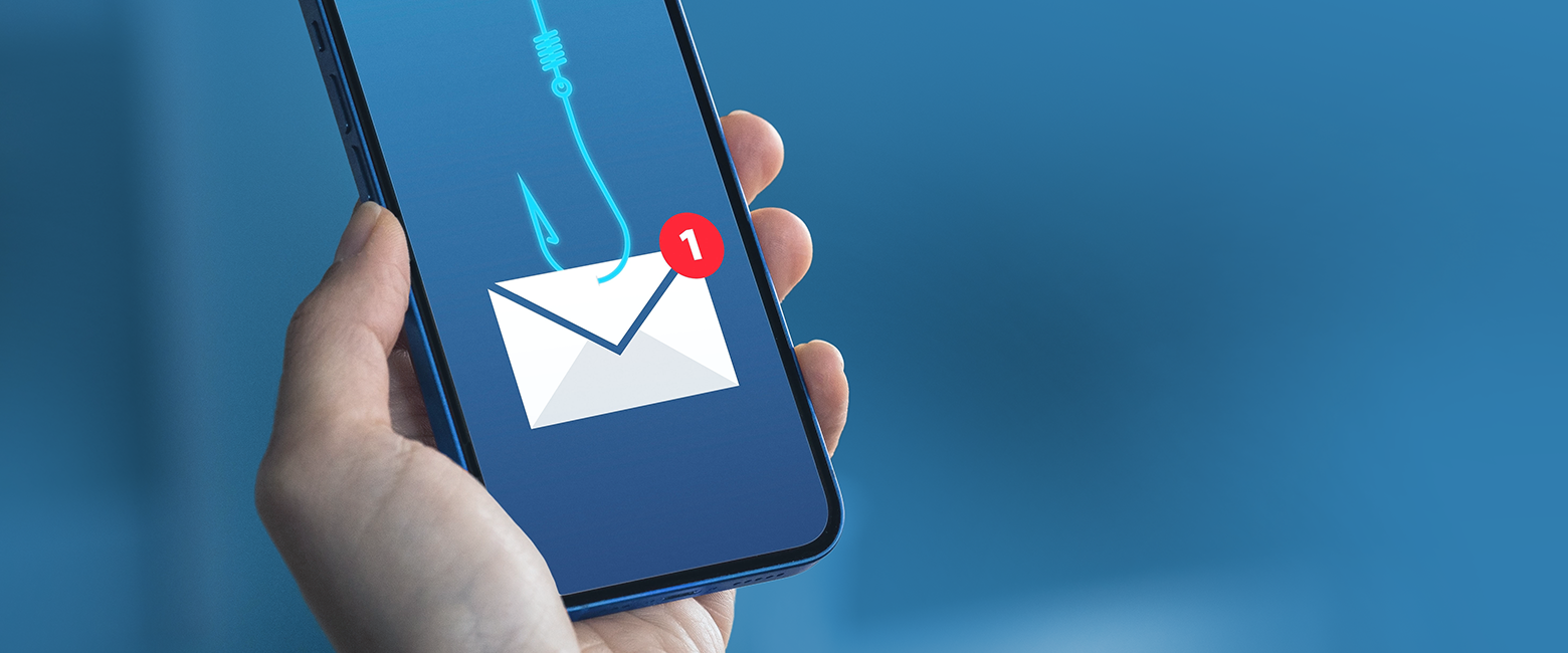 A smartphone with a red "stop" sign on the screen, surrounded by a pile of spam emails.