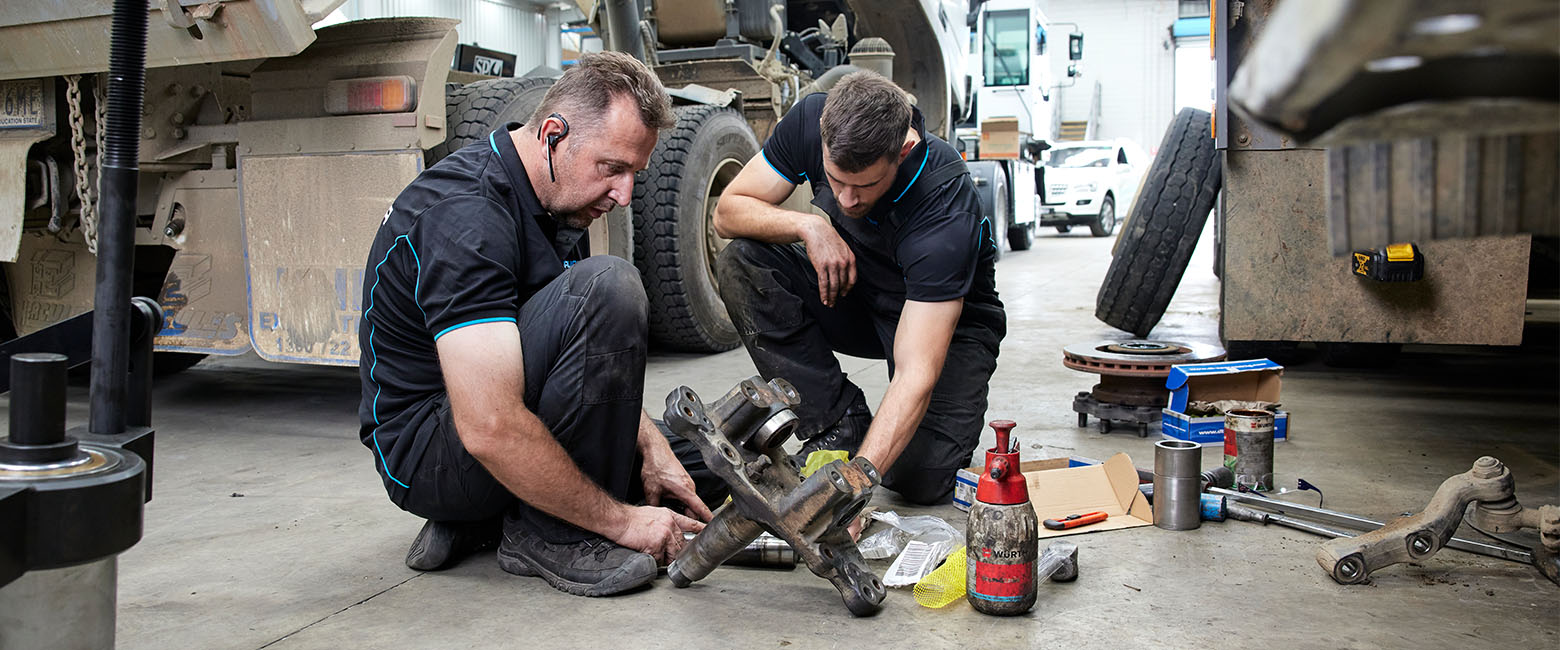 Two men working on engine