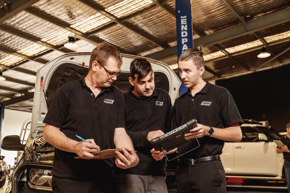 Three men looking at tablet