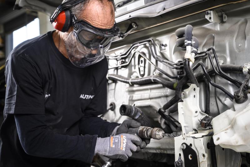 Man using equipment on engine