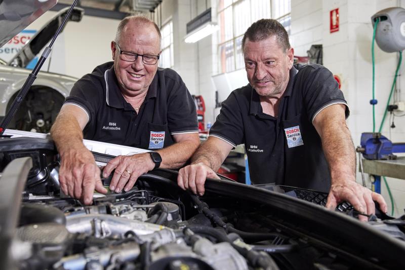 Two men working on car