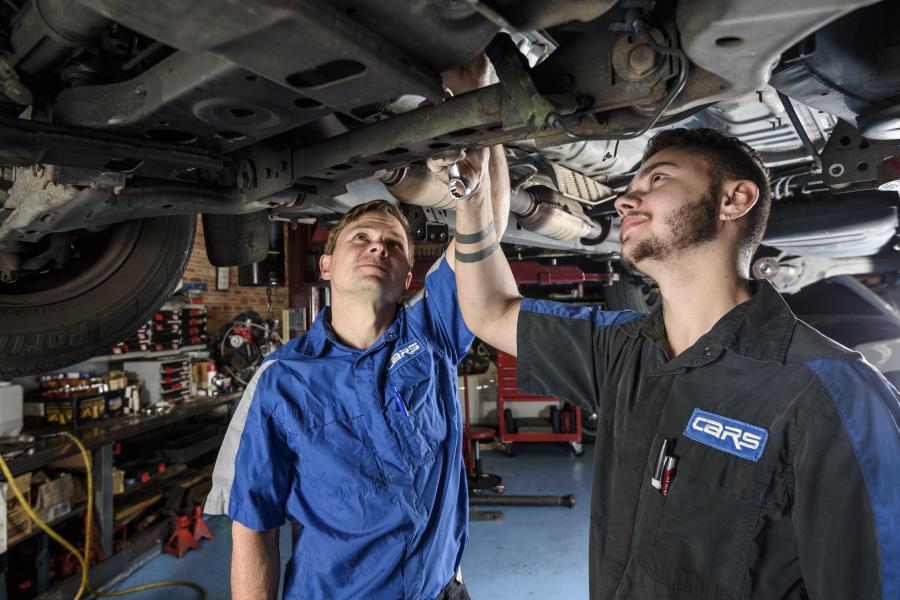 Technicians working on car