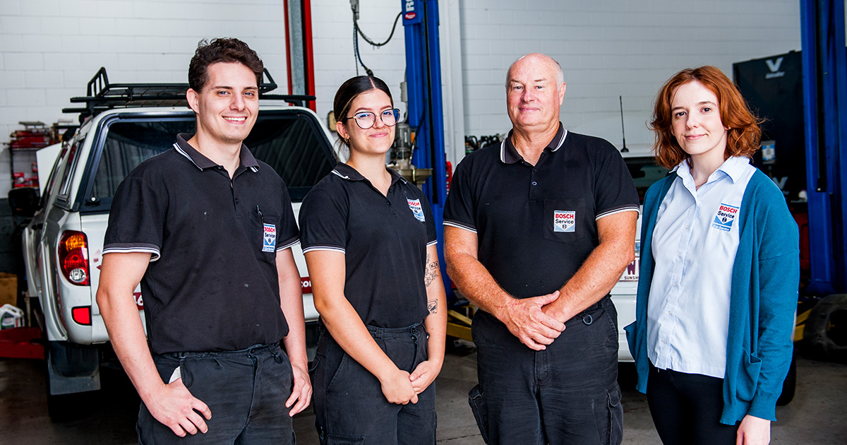 John Edwards standing alongside his staff including 2023 Capricorn Rising Stars winner, Chelsea inside his workshop.