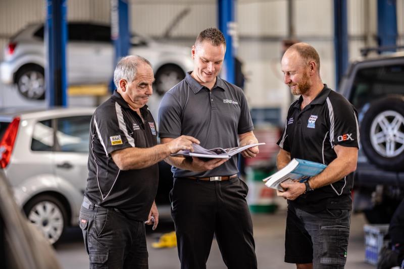 Three men in workshop