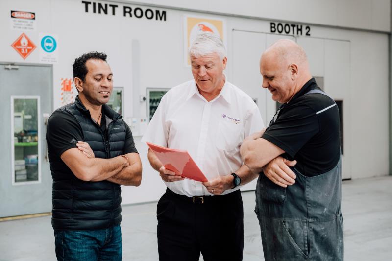 Three men in workshop