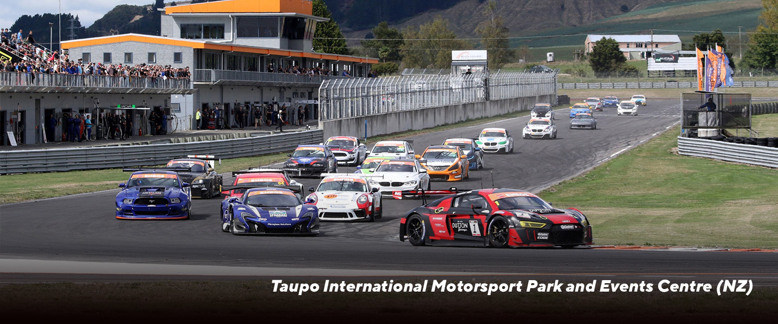 Cars speeding around Taupo International Motorsport Park in New Zealand.