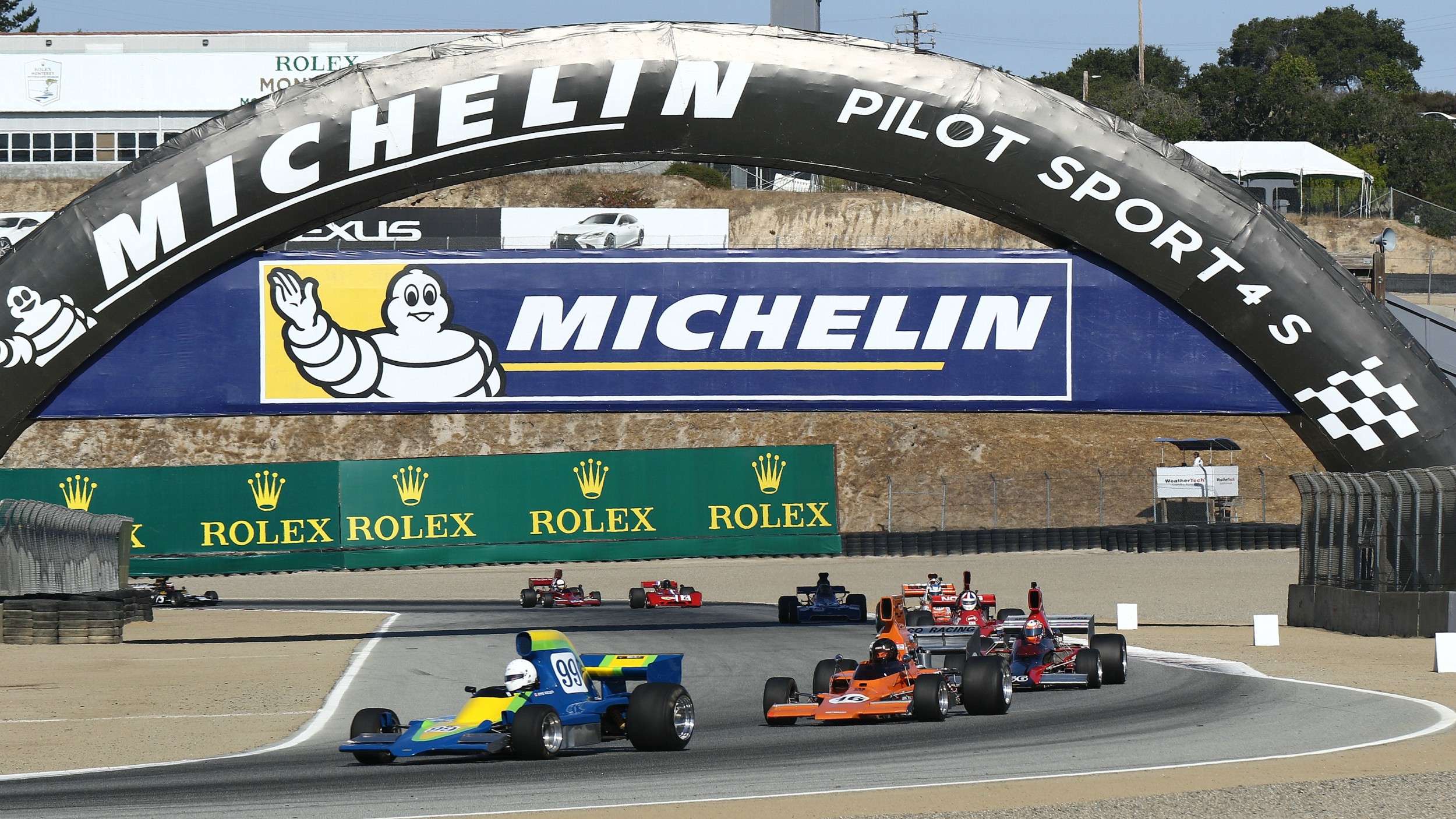 Speeding race cars on track.