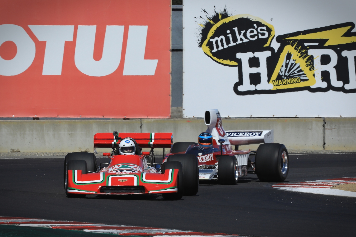 A pair of racing cars competing on a track