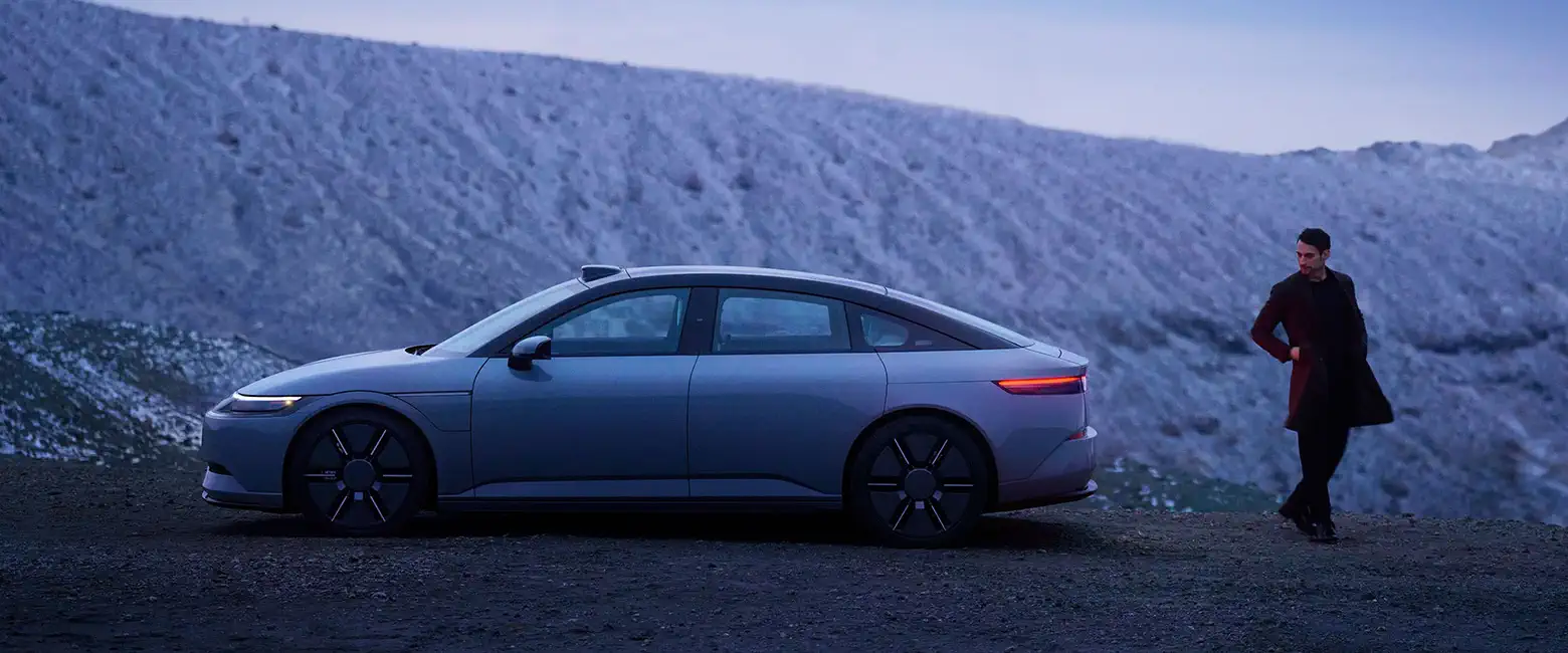 Sony Afeela standing next to a car on a mountain.