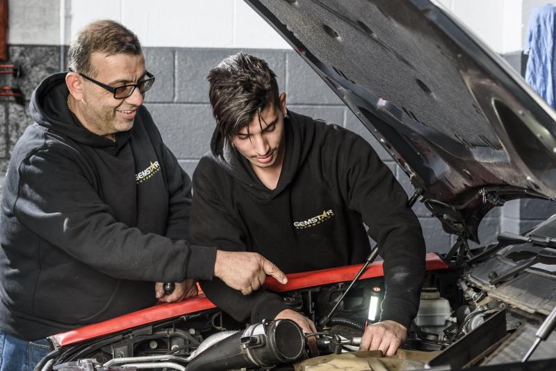 Two men working on car