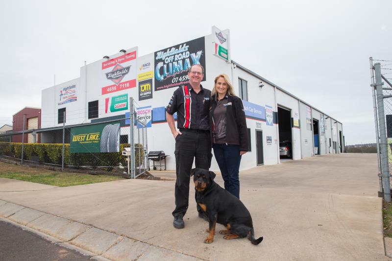 Man and woman in front of workshop