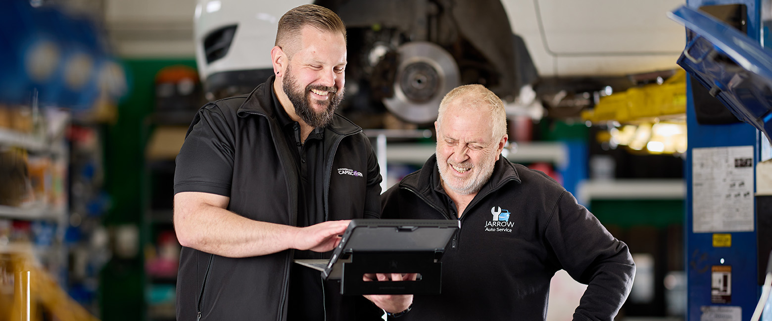  Capricorn Area Manager and Stephen Rowe review information on a tablet in a garage at Jarrow Auto Service
