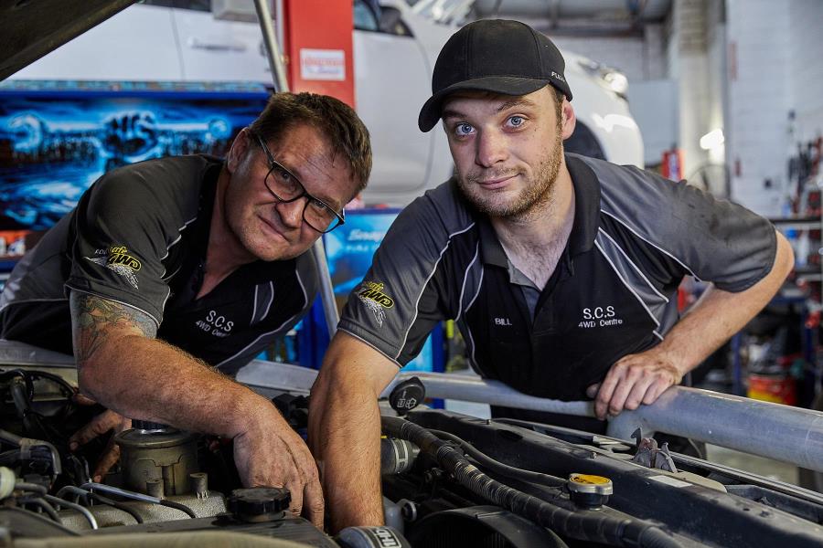 Technicians working on engine