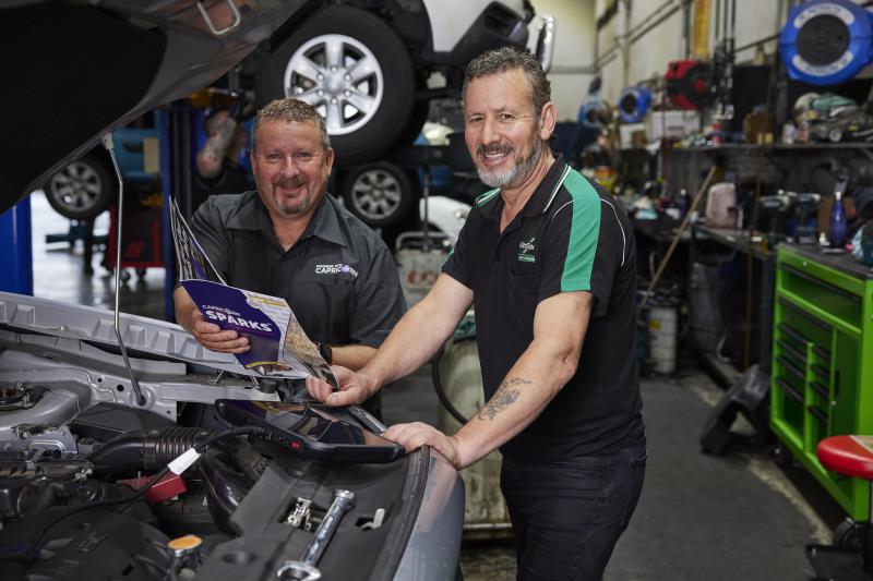 Two men at car