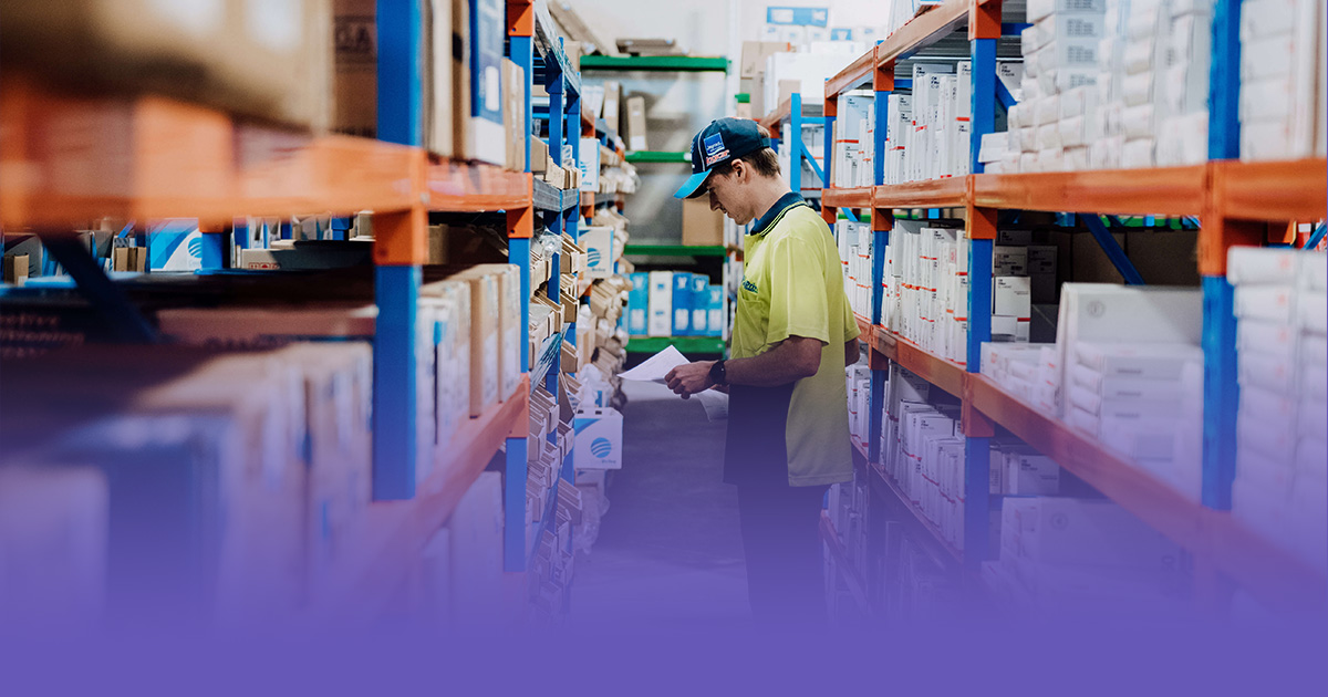 Preferred Supplier team member in a warehouse preparing automotive parts for Capricorn Members, representing reliable trade relationships