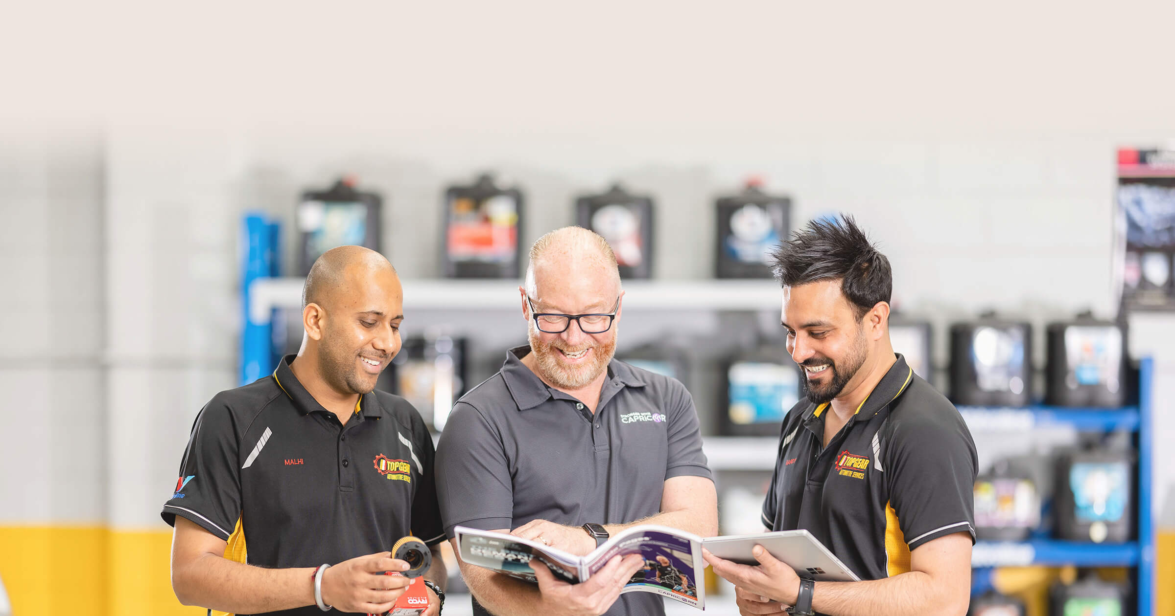 Capricorn Area Manager in middle of two Capricorn Members sharing insights in a workshop.