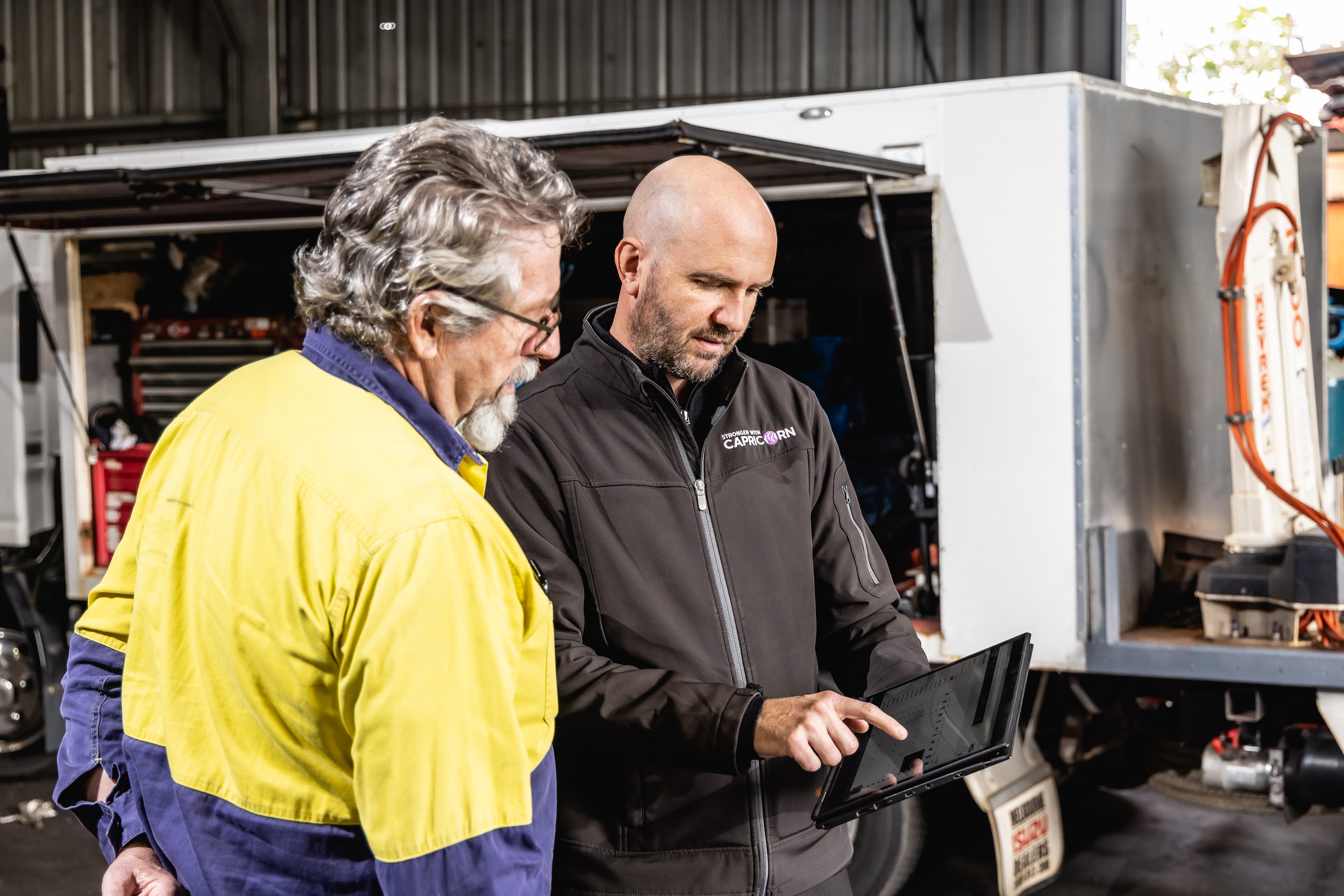 Capricorn Area Manager showing information on a tablet to a workshop professional